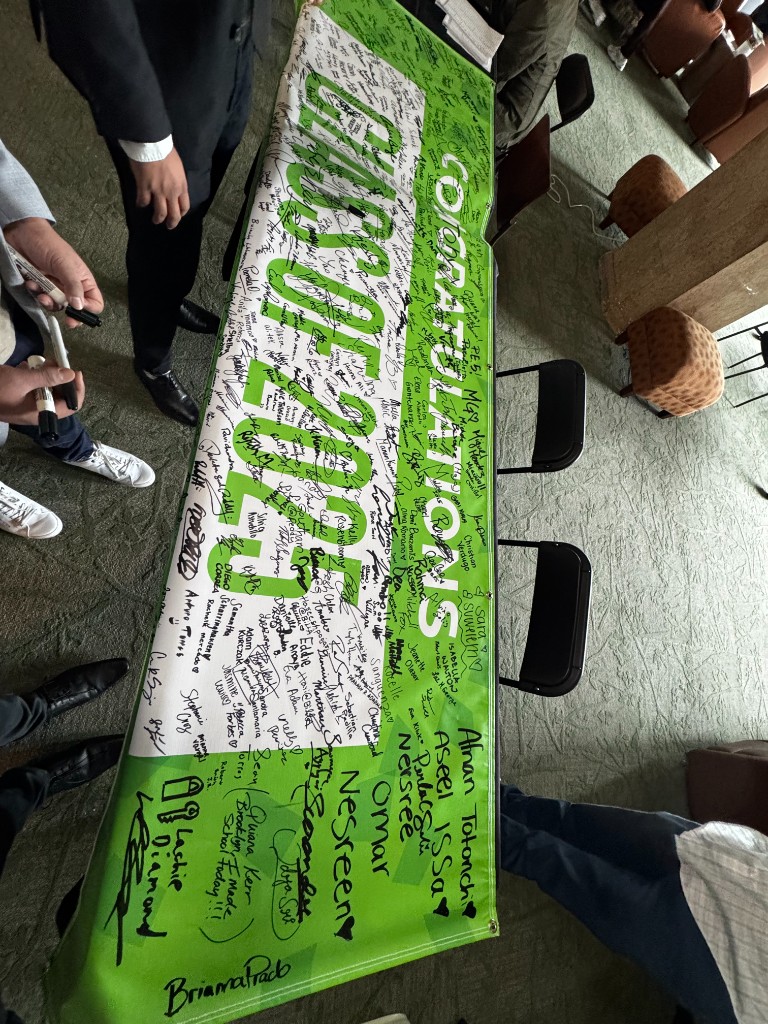 Congratulations banner — signed by everyone